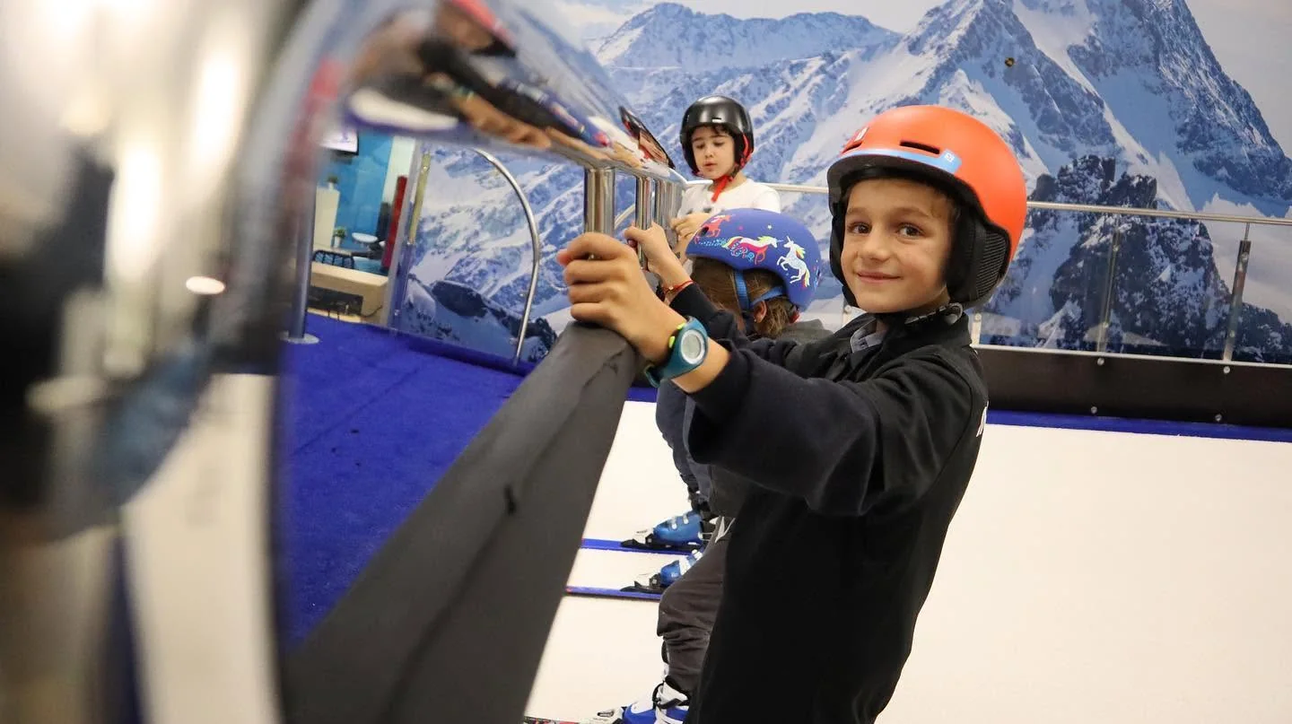 Children Learning on a PROLESKI Ski Treadmill Children in helmets practising on an indoor ski treadmill at Infinit Ski