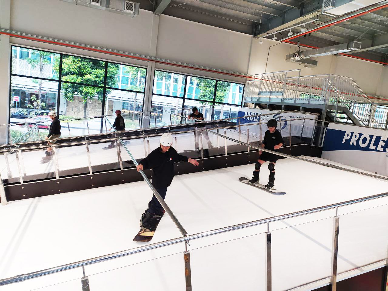 Snowboarders training on PROLESKI simulators in an indoor ski club