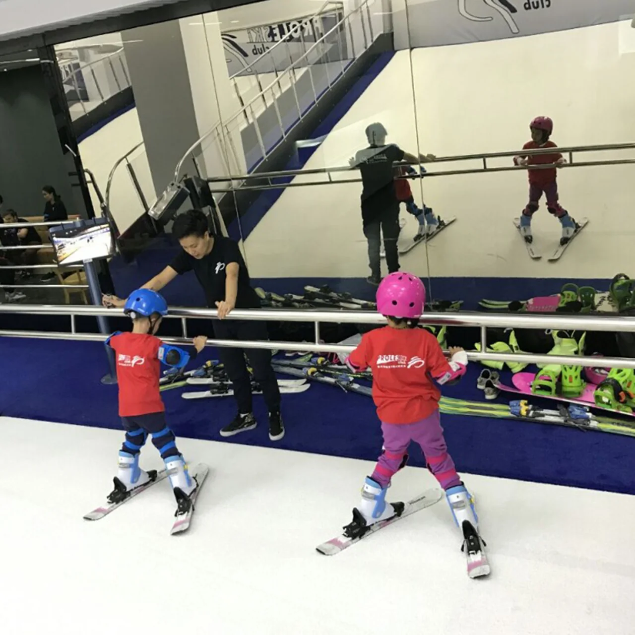 Children practising skiing with an instructor on a PROLESKI simulator